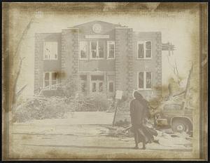 Oak Lawn, Ill. - Unidentified nun examines the facade of St. Gerald's School here 4/22. Virtually destroyed school was unoccupied when tornado swept through here late 4/21. Tornado caused many deaths and injuries and property damage was extensive.