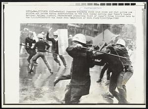 Tokyo Riot – Radical Japanese students wield iron pipes and riot police use shields and batons during confrontation in the rain Monday morning near Tokyo’s Kamata National Railway Station. Students were protesting visit of Japan’s Prime Minister Sato to the U.S.