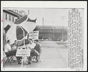 Picket Line Comfort--Strikers at the Steelton, Pa., plant of the Bethlehem Steel Co. do their picketing in comfort, beneath a beach umbrella and with coffee and cards. Taking it each on picket duty are (left to right) Joseph Bazdar, president of Local 1688 of the United Steelworkers of America, Lester Sennett, frank Mishenko and Steve Klipa. The nationwide strike is now in its second week.