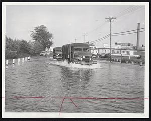 Semi-Amphibian Vehicles were these Army trucks splashing through the high water which flooded Cape Cod highways in many places. This was on Route 28 between Buzzards Bay and Wareham.