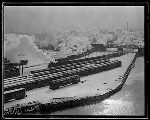 Steam or smoke rising up from railroad cars