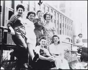 A group of mill girls were taking a lunch break in front of the Pacific Mills Lawrence, MA, 1943
