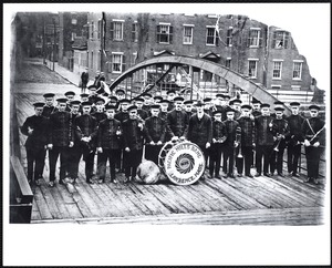 Pacific Mill Band standing in front of entrance to Upper Pacific Mills