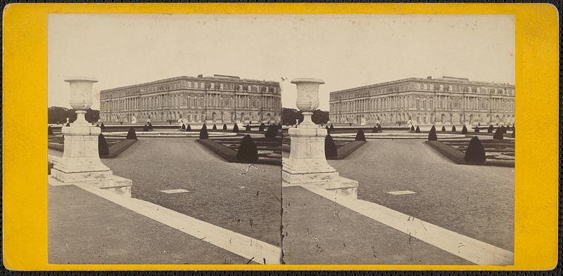 A building with a formal garden, pedestal in foreground