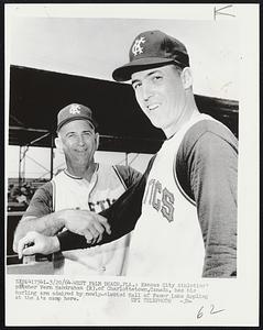 Kansas City Athletics’ pitcher Vern Handrahan (R),of Charlottetown,Canada, has his hurling arm admired by newly-elected Hall of Famer Luke Appling at the A’s camp here.