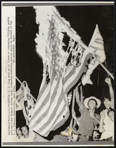 Manila: U.S. Flag goes up in flames as screaming Filipino youths anti-American slogans during rally climaxing week-long protest march by workers of the U.S. Tobacco Corporation, here 5/22.