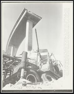 The earthquake that hit Southern California caused part of massive elevated freeway to collapse, burying the 80-ton crane (bottom) which has been used in work on the freeway interchange, which intersects US Highway Interstate 5. Miraculously, no one was killed.