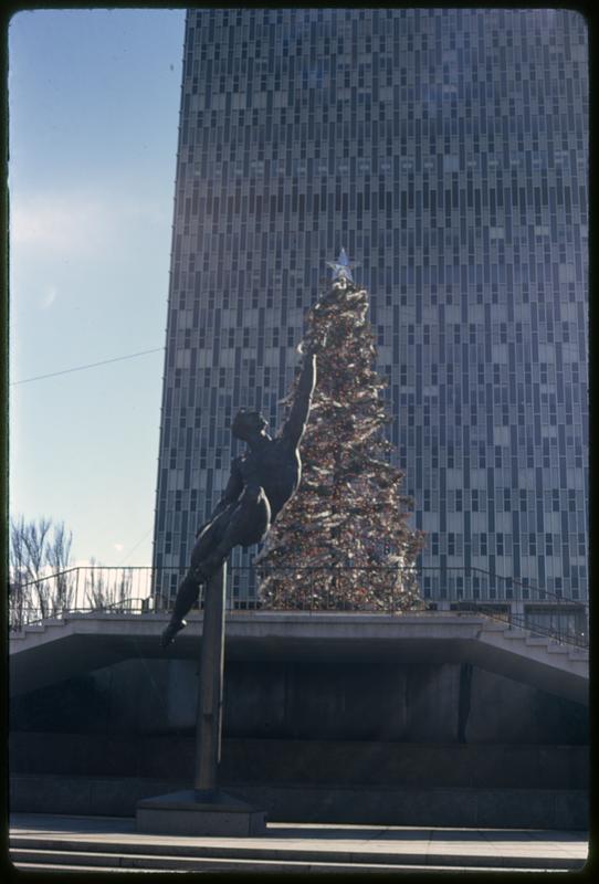 Christmas tree with Quest Eternal sculpture in foreground, Prudential Center Plaza