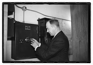 A man demonstrating how to break into a safe
