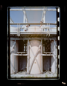 Two people standing on a metal structure