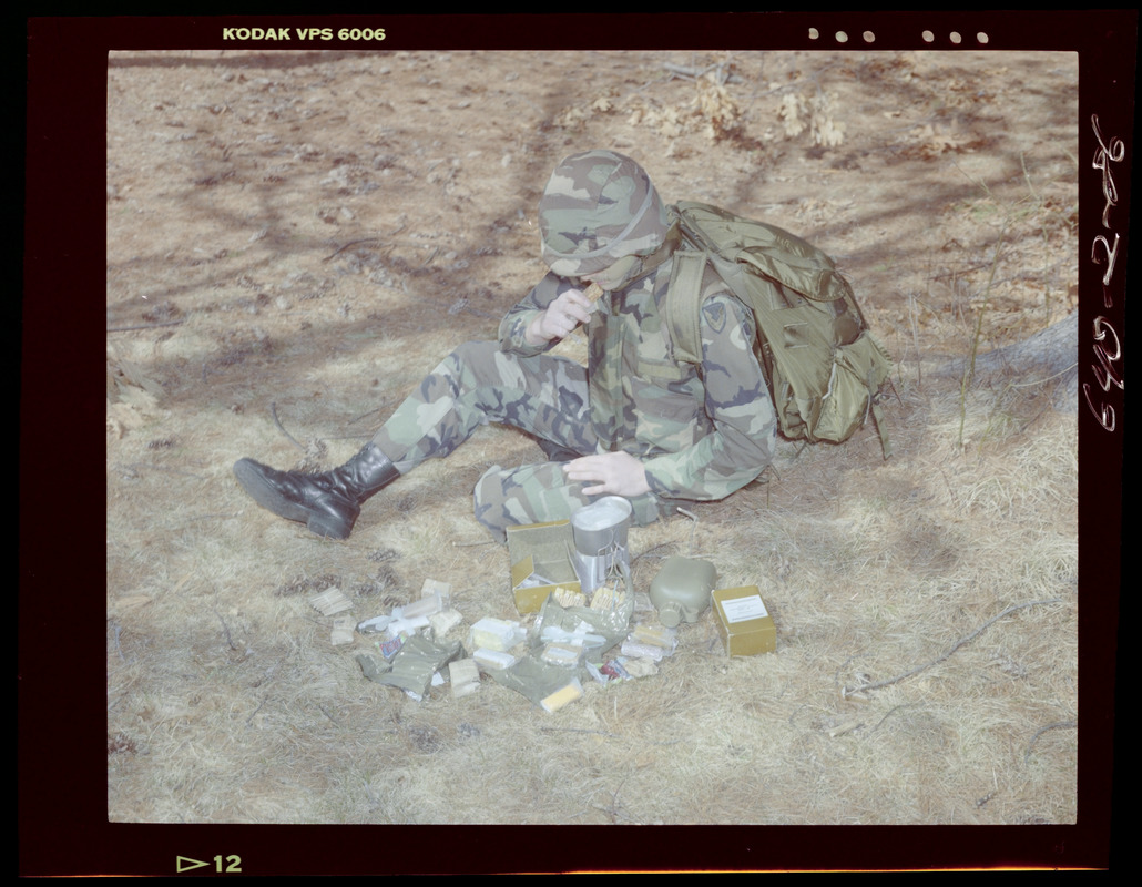 Food lab, 2 G.I. eating ration in woods