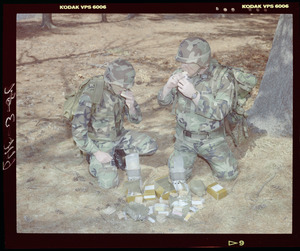 Food lab, 2 G.I. eating ration in woods