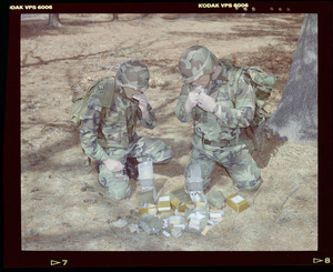 Food lab, 2 G.I. eating ration in woods