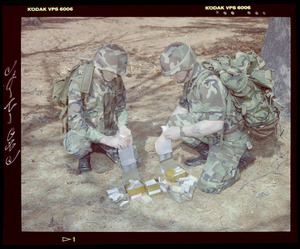 Food lab, 2 G.I. eating ration in woods