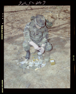 Food lab, 2 G.I. eating ration in woods