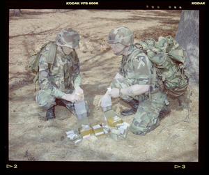 Food lab, 2 G.I. eating ration in woods