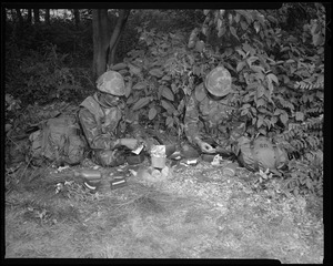 Food lab, new meal, ready to eat, out in field with GI opening pack & heating food