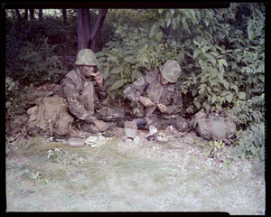 Food lab, new meal, ready to eat, out in field with G.I. opening pack & preparing food