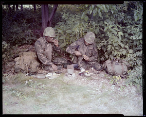 Food lab, new meal, ready to eat, out in field with G.I. opening pack & preparing food