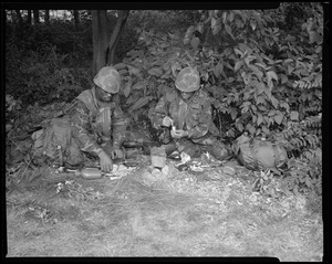 Food lab, new meal, ready to eat, out in field with G.I. opening pack & preparing food