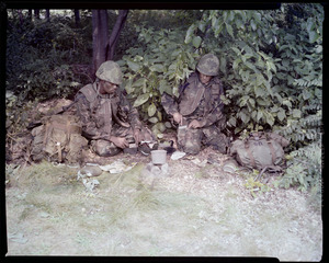 Food lab, new meal, ready to eat, out in field with G.I. opening food pack