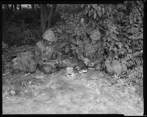 Food lab, new meal, ready to eat, out in field with G.I. opening food pack