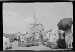 Island of St. Lucia, British West Indies, fruit market on the wharf, bow of S. S. Lady Hawkins seen in distance