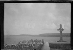 Kilronan, Inishmore, Aran Islands, Co. Galway, islanders on the wall in front of Mrs. Smith's house (Celtic, modern, memorial cross)