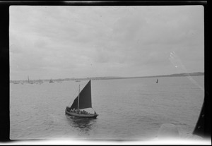 A Galway fishing boat with dark-orange-colored sail out to meet the S. S. Lützow
