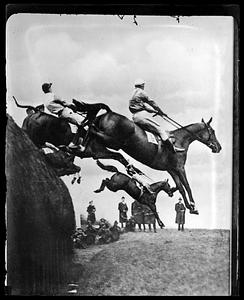 Horses jumping in a race