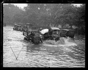 Cars driving through flooded road