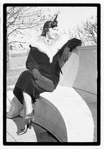 A model posing by the Oliver Wendall Holmes Memorial Sundial