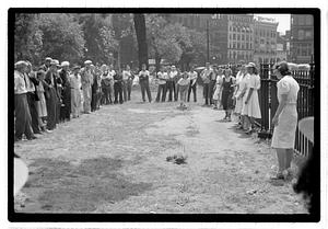 Two young women playing horseshoes