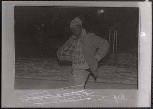 Young man posing in a jacket and winter hat