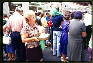 Boston - N. End 1981: A woman (L) holds volta cards for donors during St. Anthony's Feast