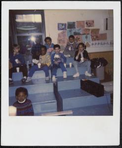 Group of children having a snack on the blue steps