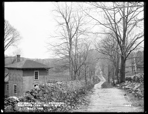 Distribution Department, Southern High Service Pipe Line, Section 19, Reservoir Lane, station 4, Michael McGrady's house and land on the north side of lane, from the northwest; Webber's Waste Weir (Cochituate Aqueduct), in middle ground, right, Brookline, Mass., May 2, 1898