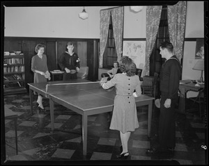 Servicemen playing table tennis with girls