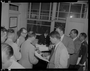 U.S.S. Bennington aircraft carrier explodes off coast of Rhode Island. Military personnel standing in an office