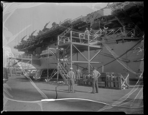 U.S.S. Bennington aircraft carrier explodes off coast of Rhode Island. Military personnel working beside an aircraft carrier in dry dock