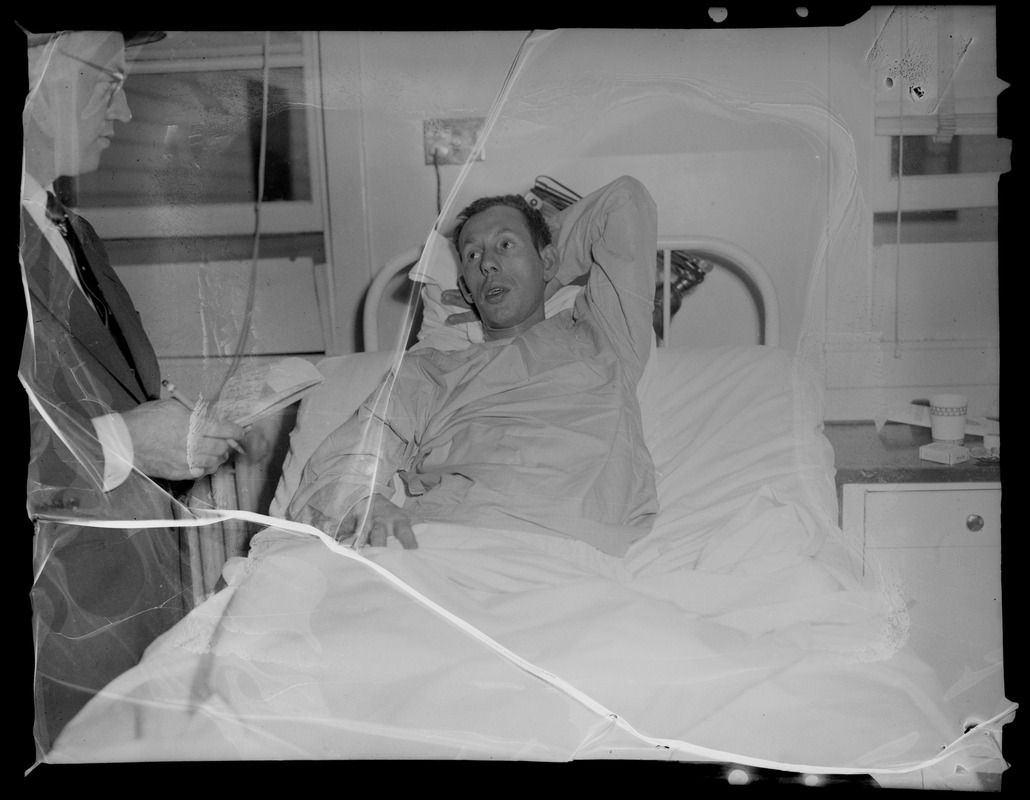 An injured person lying in a hospital bed, likely military personnel injured in the U.S.S. Bennington aircraft carrier explosion off coast of Rhode Island