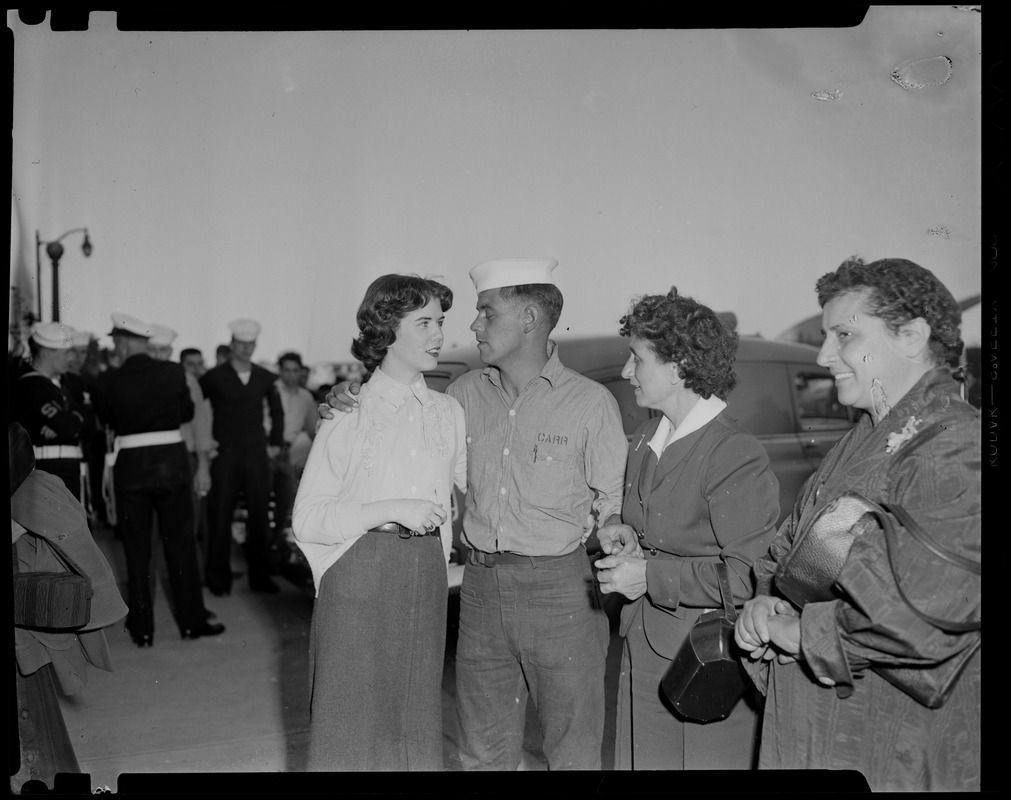 U.S.S. Bennington aircraft carrier explodes off coast of Rhode Island. Military personnel standing with three women