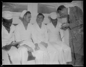 U.S.S. Bennington aircraft carrier explodes off coast of Rhode Island. Seated sailors speaking with journalists