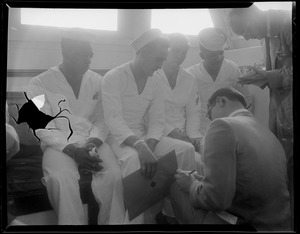 U.S.S. Bennington aircraft carrier explodes off coast of Rhode Island. Seated sailors speaking with journalists