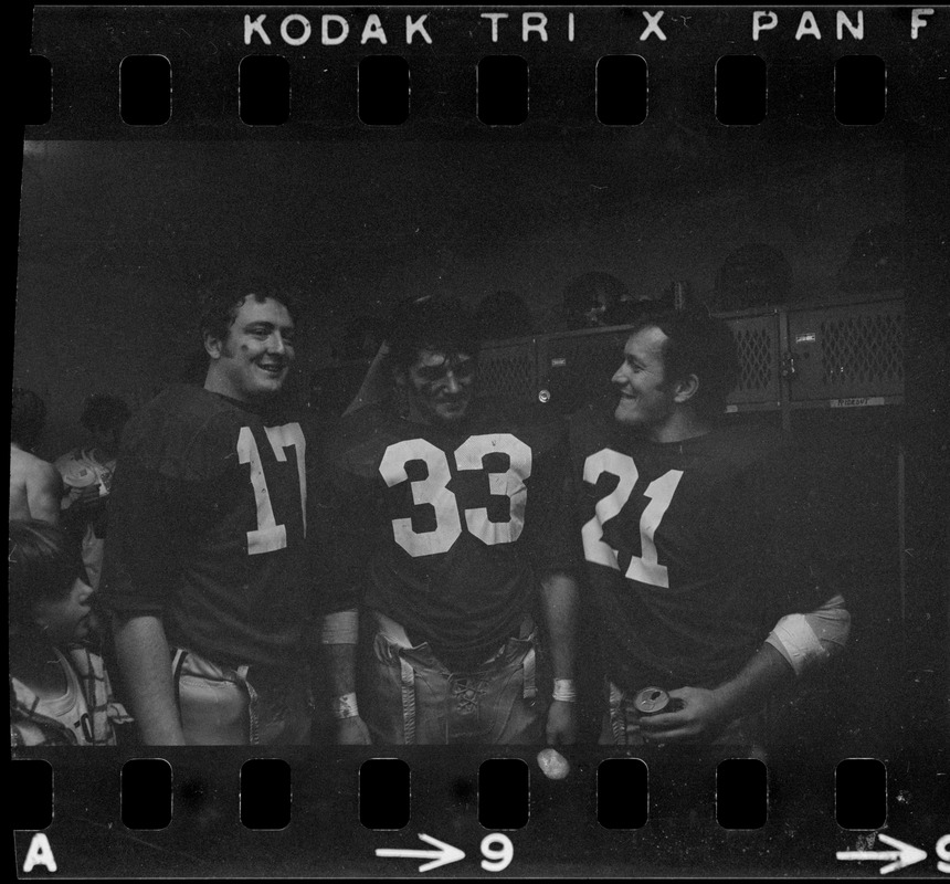 Boston College football players Frank Harris, Fred Willis, and George Gill celebrate after win against Holy Cross