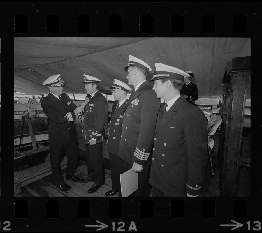 Rear Adm. Joseph Wylie presents medals to four Navy officers aboard his flagship, the U.S.S. Constitution. Receiving the decorations are, from left: Lt. Richard Pearsall, Lt. Cmdr. Ronald Scott, Capt. Karl Christoph, and Ens. Herbert Marks at medal ceremony on the U.S.S. Constitution