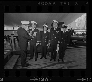 Rear Adm. Joseph Wylie presents medals to four Navy officers aboard his flagship, the U.S.S. Constitution. Receiving the decorations are, from left: Lt. Richard Pearsall, Lt. Cmdr. Ronald Scott, Capt. Karl Christoph, and Ens. Herbert Marks at medal ceremony on the U.S.S. Constitution