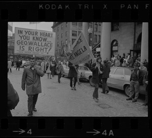 Demonstrators carrying signs - for and against Alabama Gov. George Wallace - gather outside Faneuil Hall where the presidential candidate was speaking