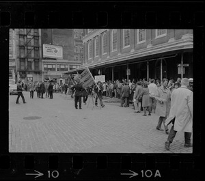 Demonstrators carrying signs - for and against Alabama Gov. George Wallace - gather outside Faneuil Hall where the presidential candidate was speaking