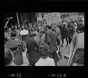 Demonstrators carrying signs - for and against Alabama Gov. George Wallace - gather outside Faneuil Hall where the presidential candidate was speaking